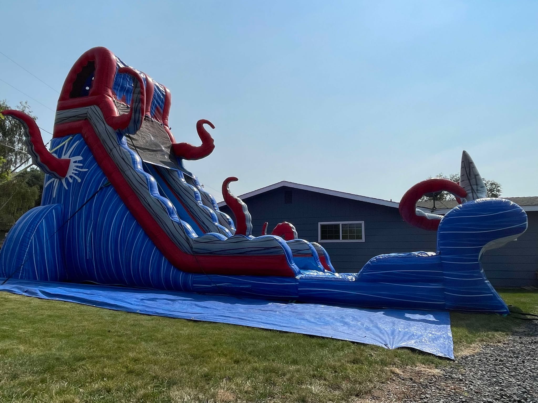 Colorful inflatable water slide set up for an outdoor party